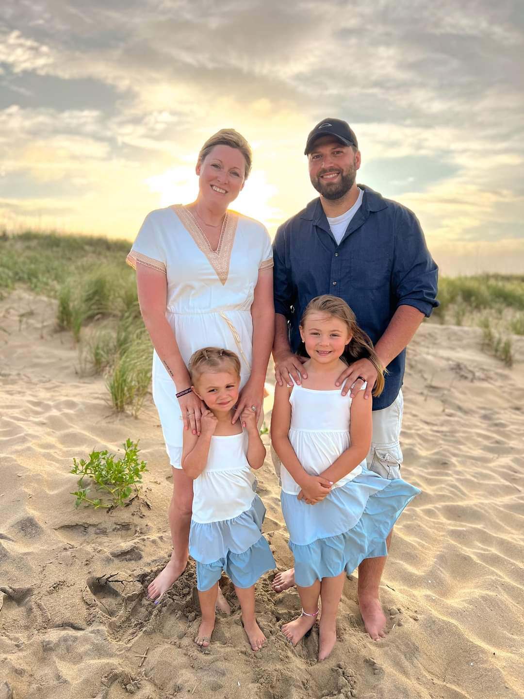 Meagan pictured with her husband and children at the beach